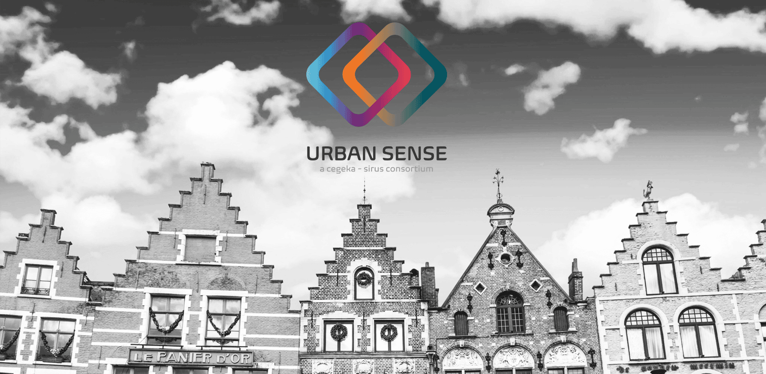 Urban Sense logo displayed over a black-and-white photograph of Ghent with historic Flemish-style buildings under a cloudy sky.