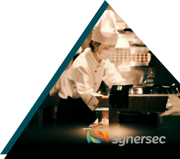 Chef working in a professional kitchen, illustrating Sirus and Synersec's Microsoft Fabric data platform project for the hosp